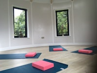 a group of yoga mats in a room with windows