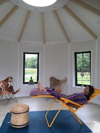 a woman laying in a hammock in a room