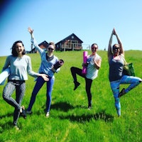 a group of women posing in a grassy field