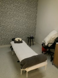 a room with a massage table and chairs