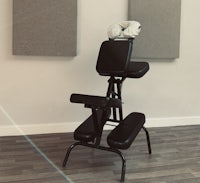 a massage chair sitting in front of a pair of speakers